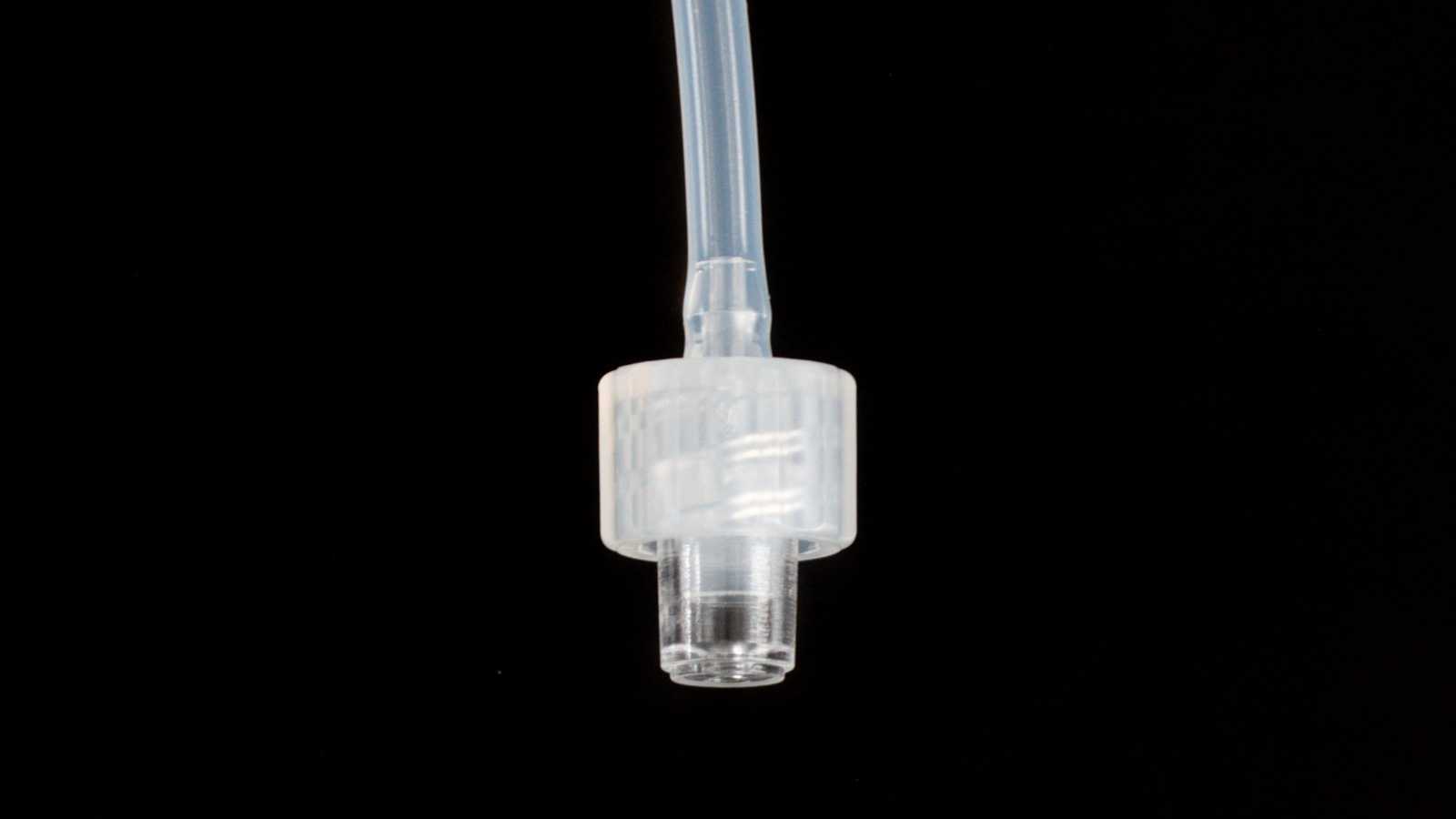 A Luer-lock interface assembled with the Luer-lock port. From top to bottom: tubing, plug, and the Luer-lock port.