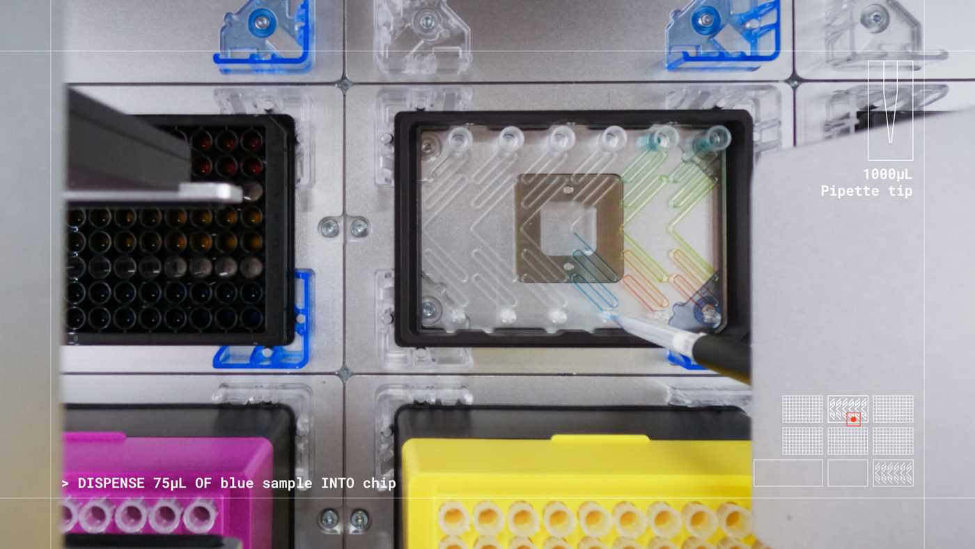 A liquid handling robot dispensing blue liquid from a 1000 μL pipette tip into a microplate format microfluidic device through a pipette interface.