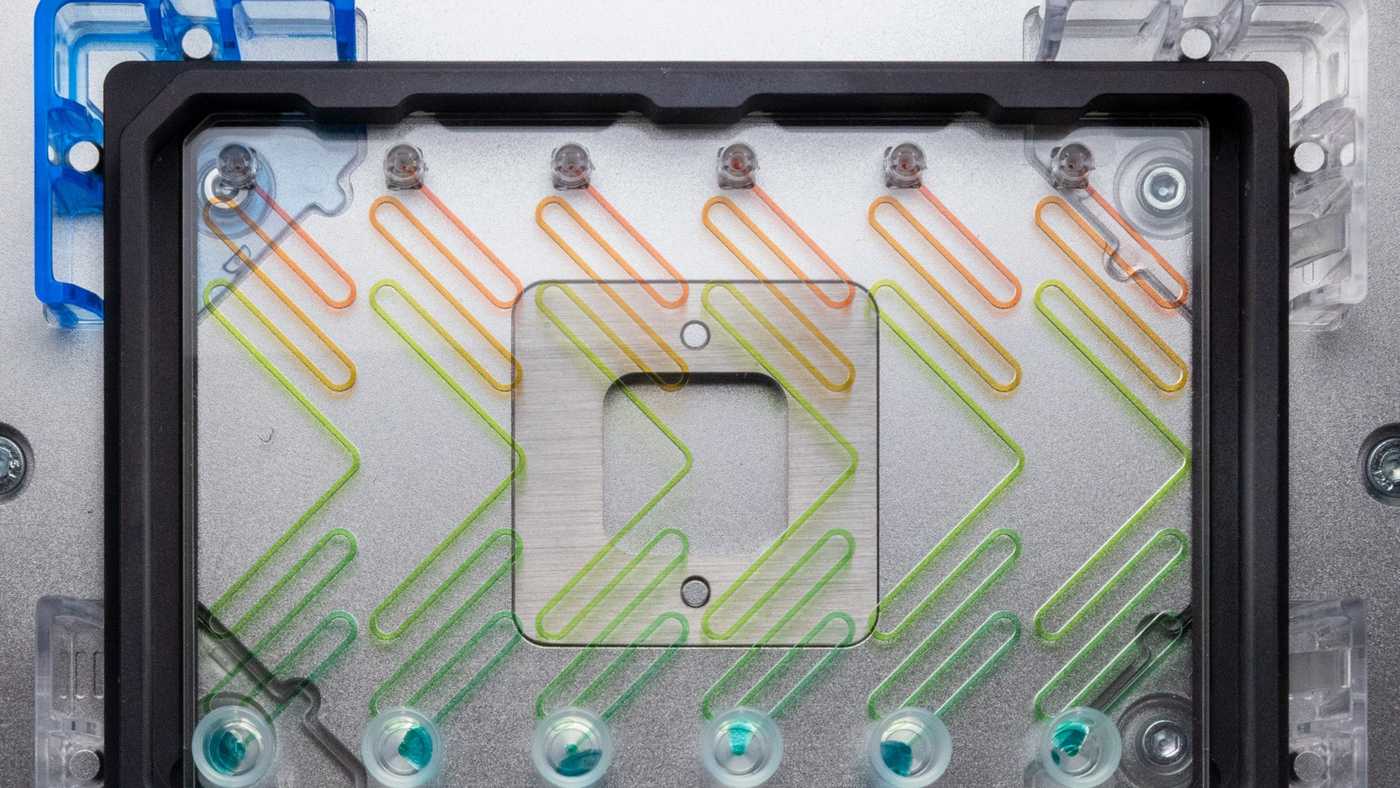 A microfluidic device in an SLAS adapter, secured to a liquid handler’s deck.